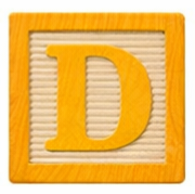 Wooden alphabet block with the letter D.