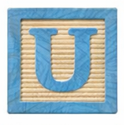 Wooden block with the letter U.